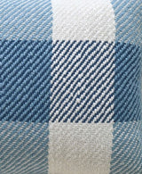 Close-up of handloom woven pillow fabric featuring textured plaid pattern in shades of blue and white with diagonal stitching detail.