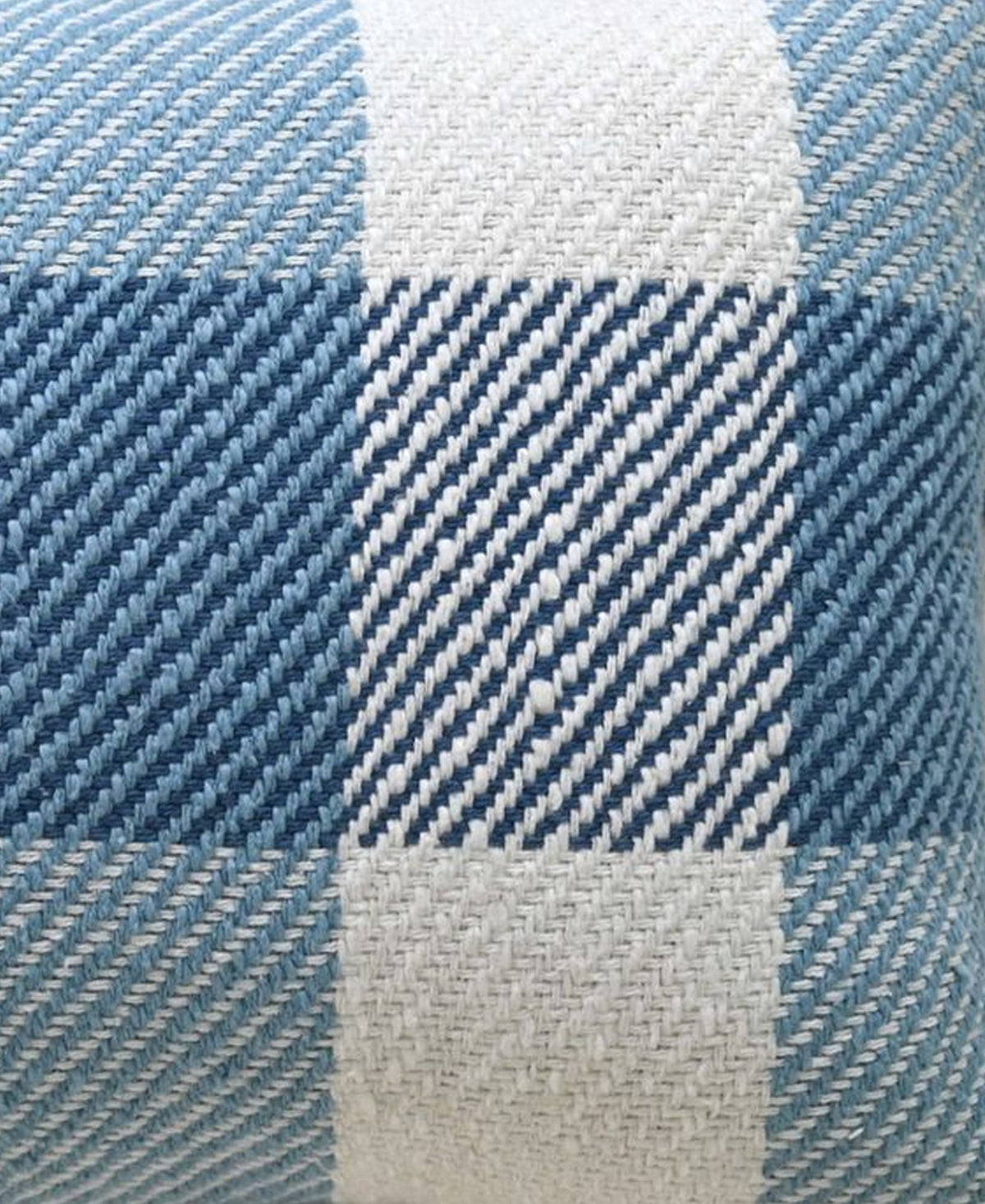 Close-up of handloom woven pillow fabric featuring textured plaid pattern in shades of blue and white with diagonal stitching detail.