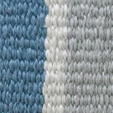 Close-up of a handwoven pillow fabric showing tightly woven blue and off-white yarns with a subtle vertical stripe pattern.