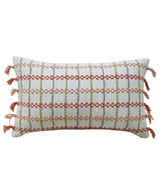 Rectangular decorative throw pillow with white base, featuring horizontal and vertical woven stripes in peach, red, and green, accented with peach tassels on the shorter sides.