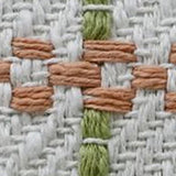 Close-up of handwoven pillow fabric showing white base with knotted terracotta horizontal accents and vertical olive green threads.