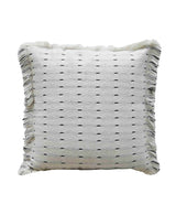 Square white handwoven decorative pillow with small black dash accents and fringe detailing along the edges, measuring 20 by 20 inches.