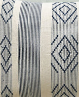 Close-up of a jacquard woven throw pillow with alternating vertical stripes and diamond patterns in black on a natural beige background.