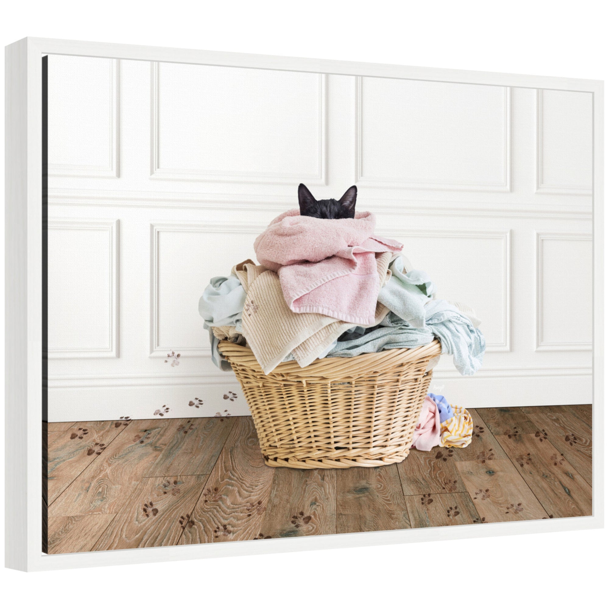 Framed canvas art showing a cat resting in a basket with folded laundry in a traditional laundry setting