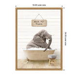 Young elephant sitting in a vintage bathtub filled with bubbles against a white shiplap wall with a wooden sign above reading 'Wash Yer Trunk' and a stool with folded towels nearby.