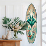 Surfboard-shaped wall art featuring a teal manta ray surrounded by sea creatures like starfish and shells on a wood plank background, displayed next to a wooden dresser with plants.