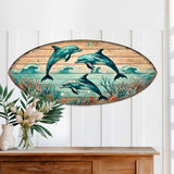 Dolphin Dance Surfboard Wall Art showing three vibrant dolphins jumping through waves with coral and bubbles on a wooden surfboard shape