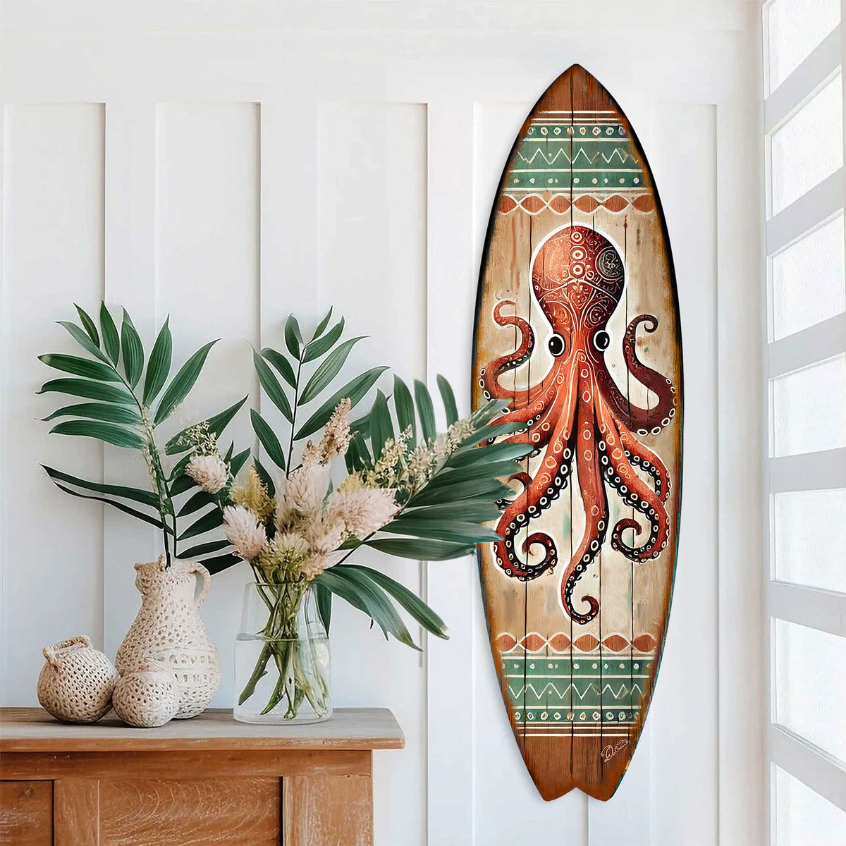 Hand-painted surfboard wall art featuring a detailed red octopus with tribal patterns on a natural wood background accented by green and white geometric bands