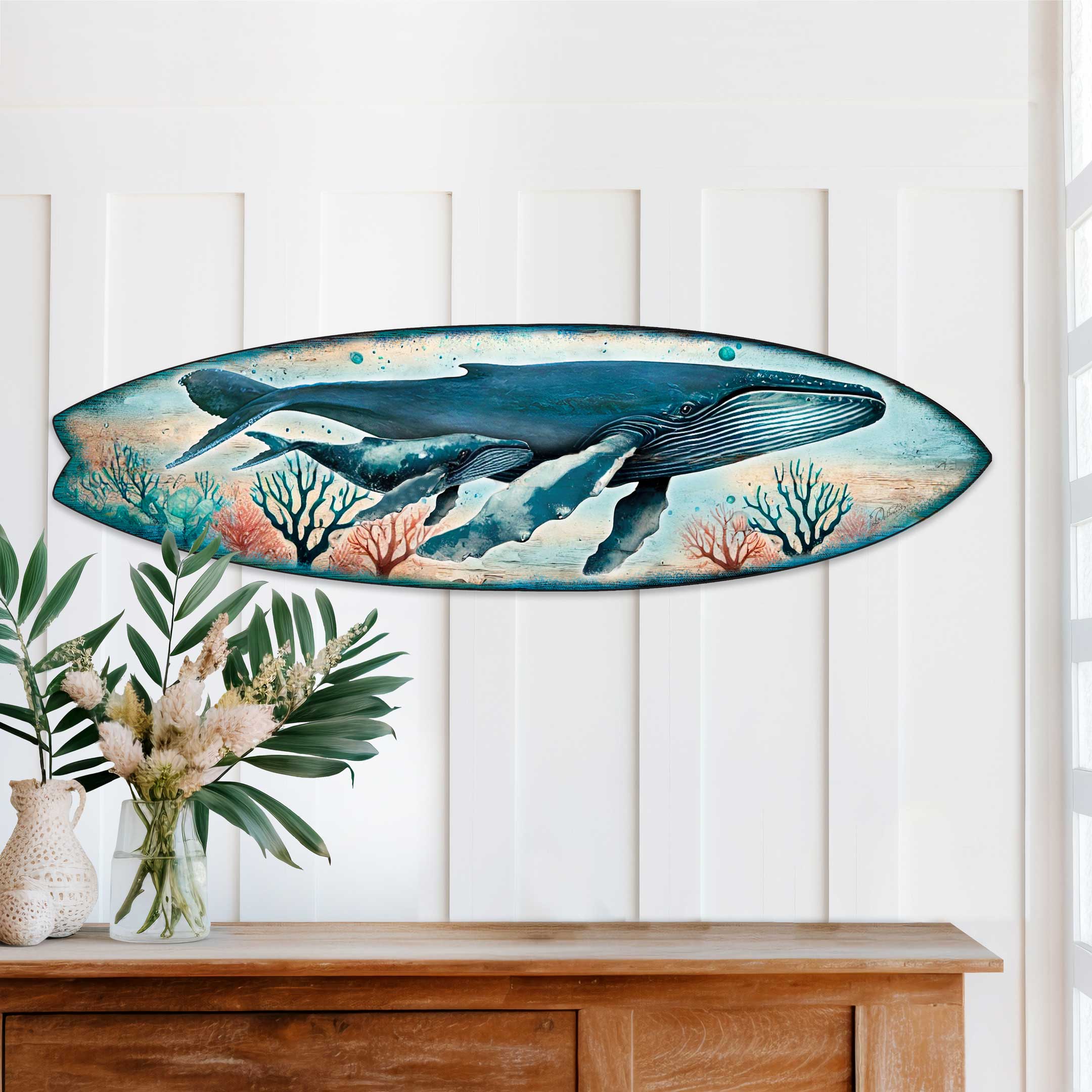 Whale Surfboard Wall Art showing a mother whale and calf swimming through blue waters on a wooden surfboard shape
