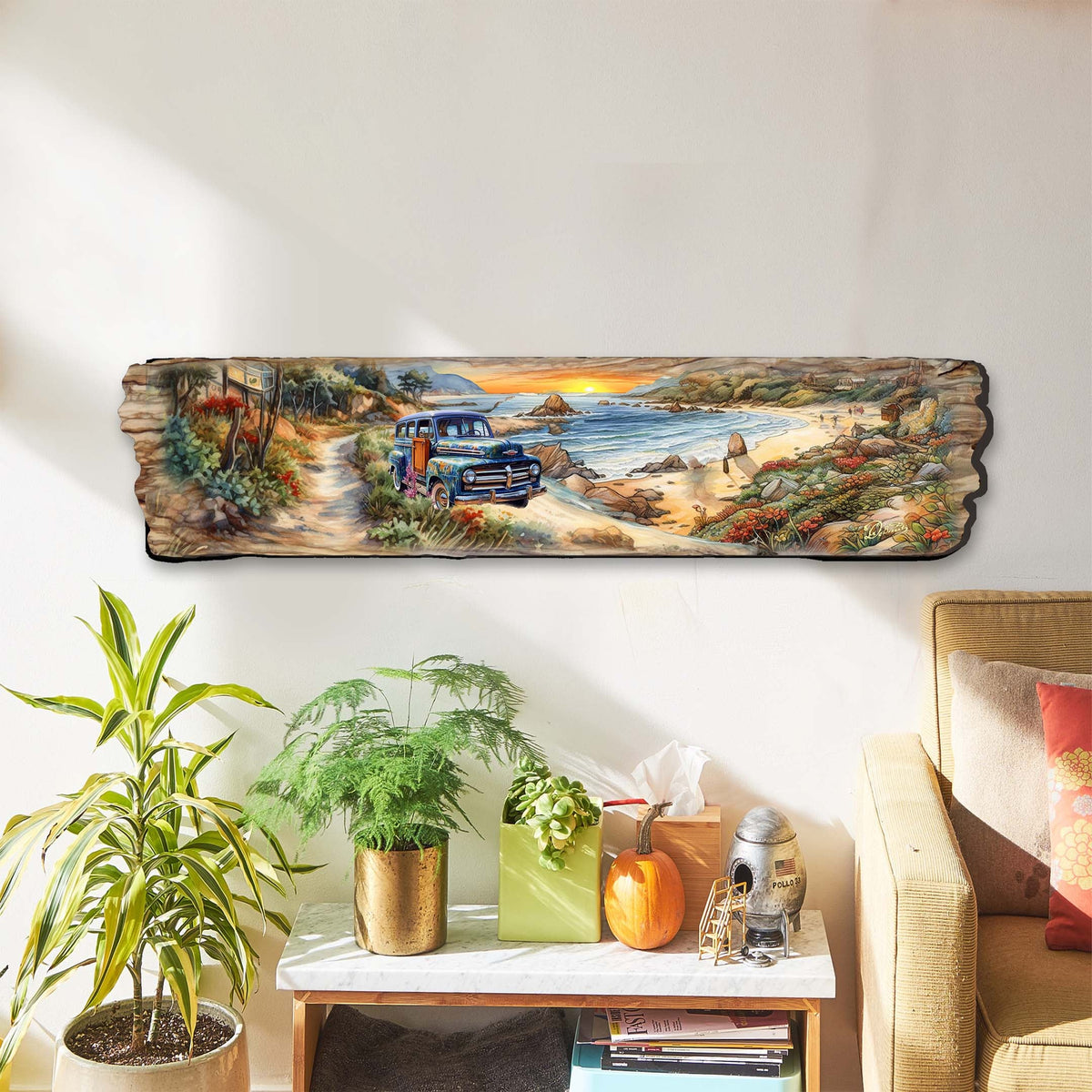 Long wooden wall art depicting a coastal scene with a vintage blue truck on a sandy path, vibrant autumn foliage, and a rocky shoreline under an orange sunset sky.