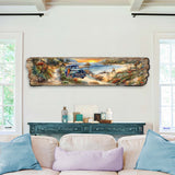 Horizontal wooden wall art depicting a coastal sunset scene with a vintage blue truck on a sandy path, surrounded by foliage and rocky shoreline.