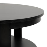 Close-up of a round black wood coffee table with thick edges and a lower shelf visible underneath, showing a smooth matte finish.