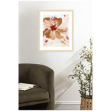 Abstract floral painting with large brown petals and red accents in a light wooden frame, hanging above an olive green armchair and a leafy plant in a woven basket.
