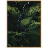 Aerial view of a winding white river cutting through a densely moss-covered green valley with steep cliffs and rugged terrain.