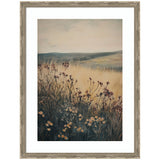 Framed art print of a soft-hued landscape featuring wildflowers in the foreground with golden grasses and rolling hills under a muted sky.