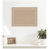Rectangular pinboard with a natural brown fabric center and a white scalloped edge frame, mounted on a white wall above a white shelf with decorative items.