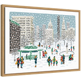 Framed canvas print showing a snowy scene in Union Square with people building snowmen and walking dogs among snow-covered trees and city buildings.