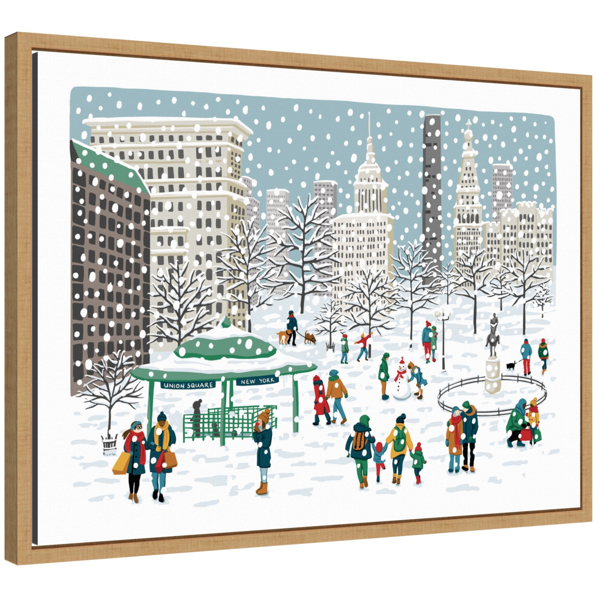Framed canvas print showing a snowy scene in Union Square with people building snowmen and walking dogs among snow-covered trees and city buildings.