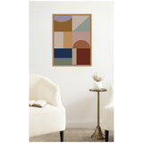 Framed abstract geometric wall art with rectangles and semicircles in muted earth tones, lavender, and navy, hanging above a brass side table between two white armchairs.