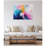 Framed abstract canvas with vibrant blue, pink, yellow, and white brushstrokes above a light gray sofa with beige and striped pillows in a neutral living room.