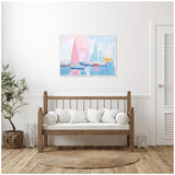 Abstract pastel sailboat harbor painting with pink, blue, and orange sails above calm water, framed and hung on a white wall over a wooden bench with white cushions.
