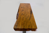 Honey-toned wooden sofa table top with natural live edges and visible wood grain patterns, supported by sleek silver metal legs beneath.