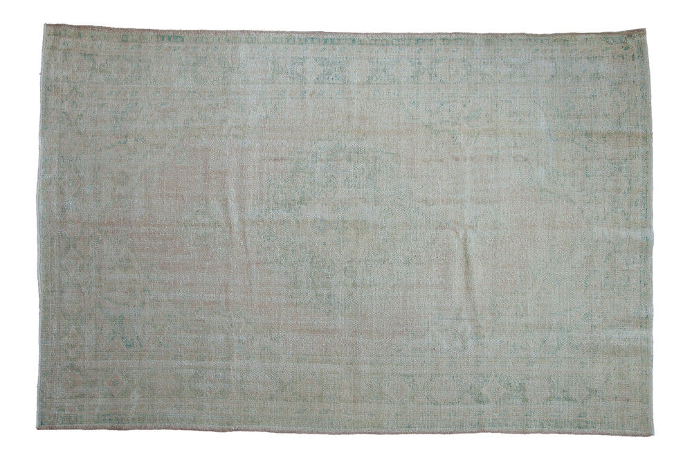 6x9.5 Vintage Distressed Oushak Carpet displaying a roundel center medallion and floral main border in dusty rose and seafoam green tones.