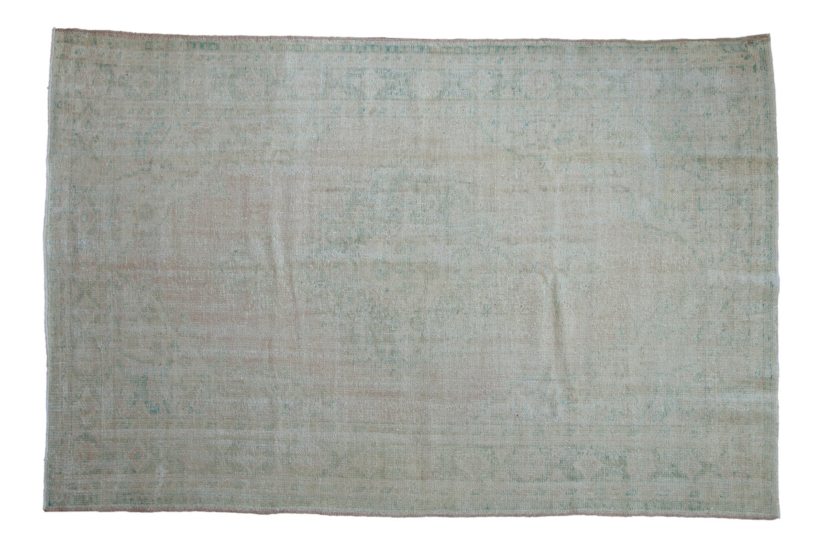 6x9.5 Vintage Distressed Oushak Carpet displaying a roundel center medallion and floral main border in dusty rose and seafoam green tones.