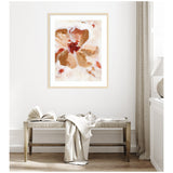 Abstract floral painting in browns and reds with soft, painterly brushstrokes, framed in light wood and hung above a rustic wooden bench with books and a draped fabric.