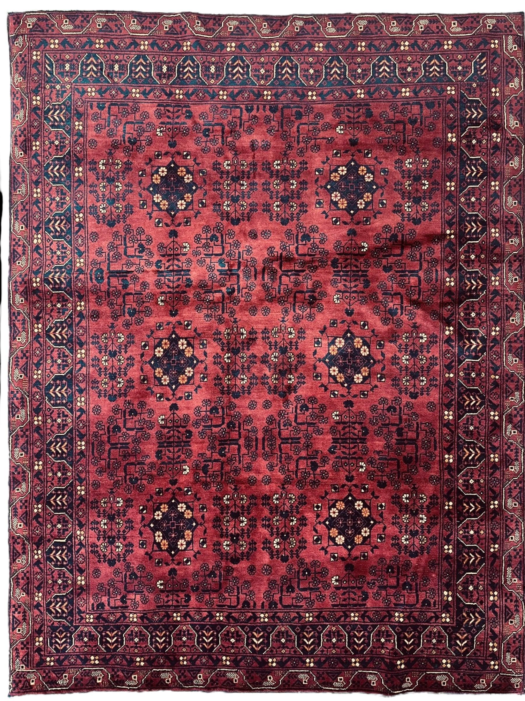 Afghani Area Rug I Turkoman Khal Mohammadi 4’9” x 6’2” displayed on wood floor with fringe edges visible