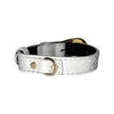 Matte white textured collar with snake scale pattern and a small gold oval metal ring accessory, shown against a white background.