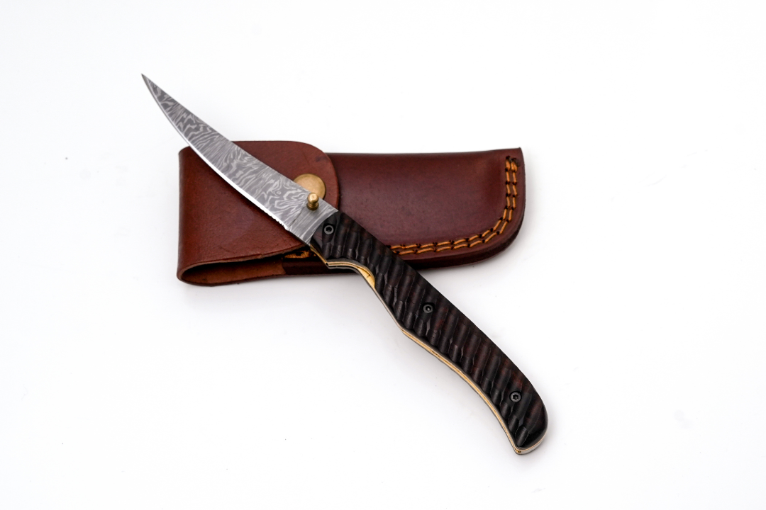 Hand-Forged Damascus Slim Folder with textured dark wood handle and intricate spine file work