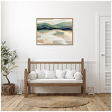 Abstract landscape painting with layered green hills and beige foreground in a wooden frame, displayed above a wooden bench with white cushions in a minimalist living room.