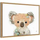 Framed canvas print of a koala portrait made from layered natural elements like leaves and moss, with soft earth tones and blue-green floral accents.