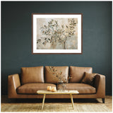 Abstract painting of an olive tree branch with muted green leaves on a beige and gray textured background, framed and hung above a brown leather sofa.