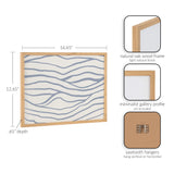 Framed abstract print with light blue coastal wave patterns on white, natural oak wood frame with minimalist profile, dimensions 16.65" by 12.65" by 0.65".