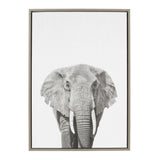 Black and white frontal portrait of an elephant with prominent tusks on a white background, framed in a simple wooden frame.