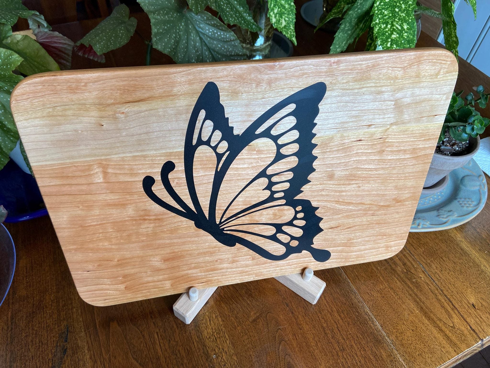 Cherry wood charcuterie board with butterfly-shaped resin inlay