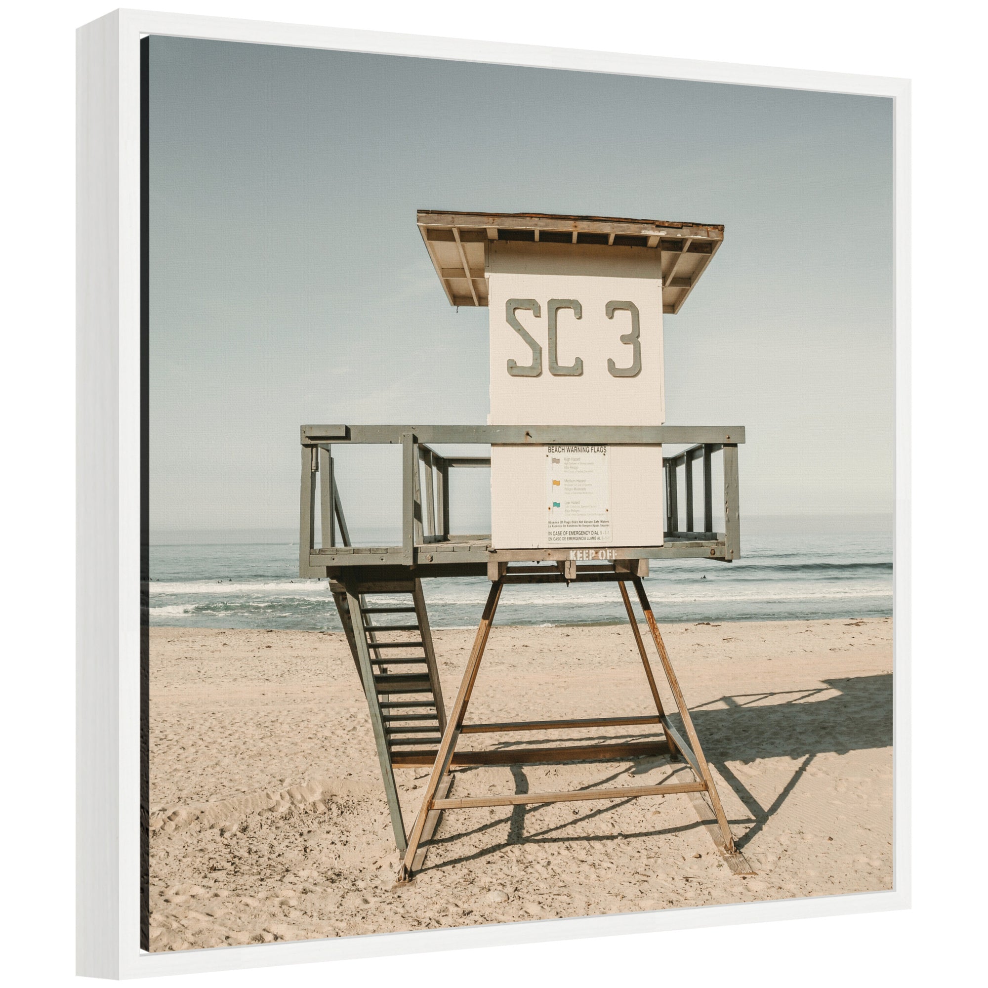 Framed canvas art depicting the Sylvie SC3 lifeguard tower on a beach, with a modern floating polystyrene frame