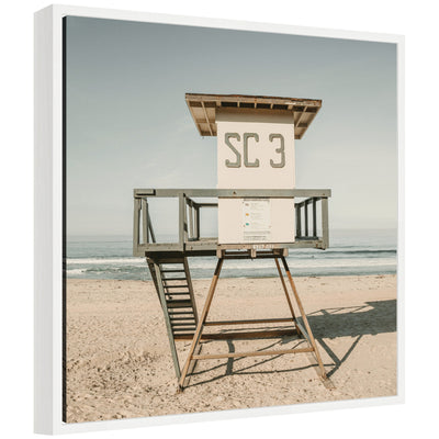 Framed canvas art depicting the Sylvie SC3 lifeguard tower on a beach, with a modern floating polystyrene frame