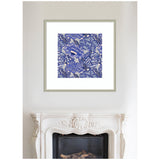 Square framed artwork featuring intricate blue floral patterns with white background, hung centered above a white ornate fireplace mantel.