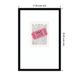 Framed wall art featuring a pink ticket with "ONE LIFE" printed over a vintage black-and-white newspaper page, displayed in a black frame measuring 17 by 25 inches.