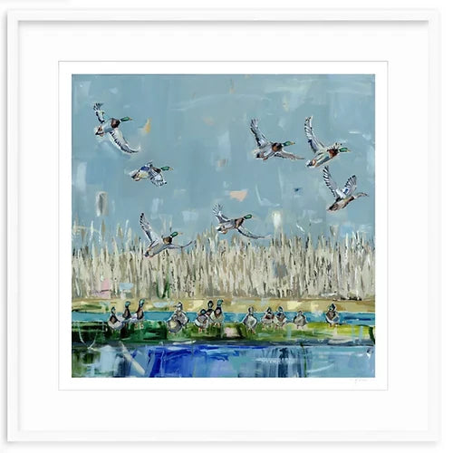 Fine art print depicting ducks flying over a marsh with tall beige grasses, reflected blue water below, and a muted blue sky background.