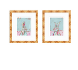 Two framed abstract bunny portraits with pastel blue and pink backgrounds, featuring textured brushstrokes and warm brown wood frames.