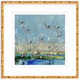Art print showing mallard ducks flying above a marsh with tall reeds and water reflecting blues and greens, framed in gold bamboo-like frame.