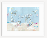 Abstract impressionist painting of eight white doves in flight against a pale blue sky and soft beige and pink background, framed in a simple white frame.