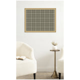 Rectangular sage green fabric pinboard with white plaid grid in a light wood frame mounted on a white wall above two white upholstered chairs and a brass side table with a white vase.