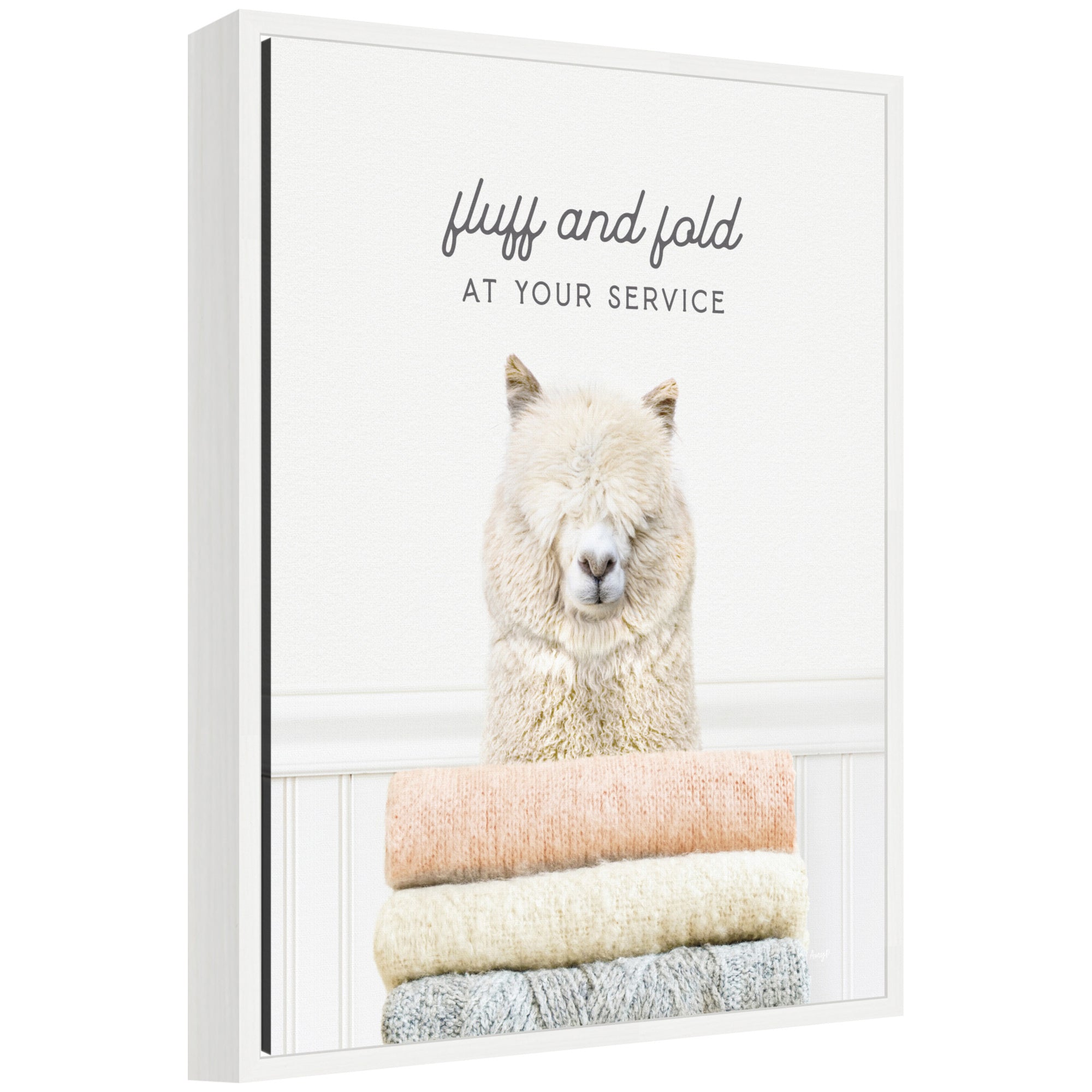 Framed floating canvas art titled 'Sylvie Alpaca Fluff and Fold' depicting an alpaca in laundry scene