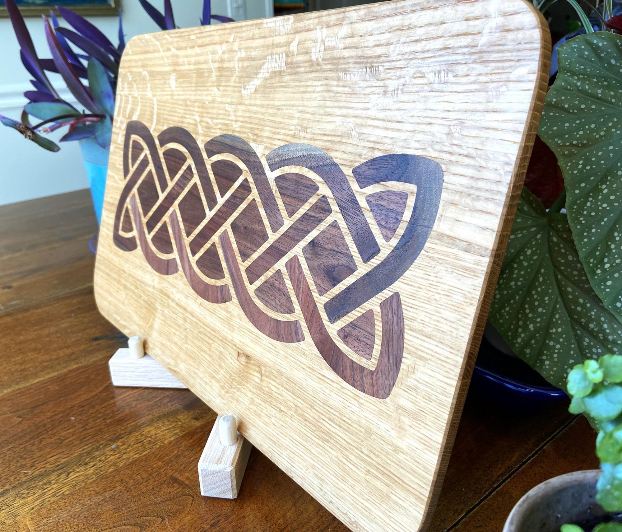 White Oak charcuterie board featuring a complex Celtic knot inlay made of Peruvian Walnut