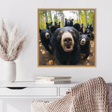 Close-up of seven black bears in a forest, with one bear's nose prominently in the foreground and green trees in the background.